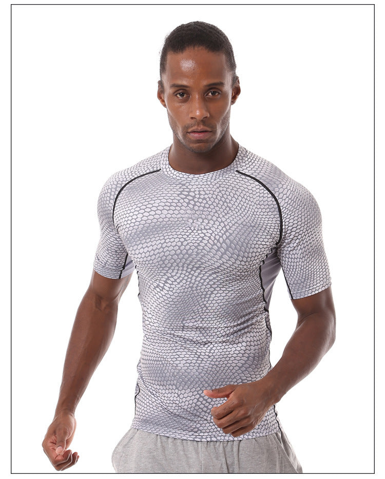 A man in a focused stance, ready to run, wears eprolos Mens Quick-Dry Serpentine Athletic Fit Compression T-Shirt for hiking and outdoor activities, paired with light gray pants against a white background.