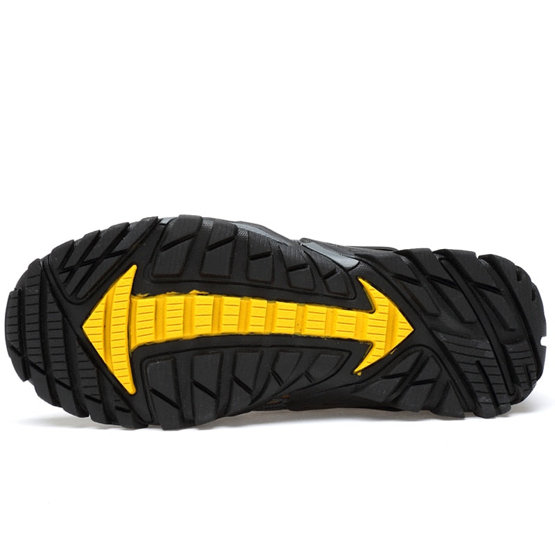 Close-up of the eprolo Mens Summer Breathable Hiking Shoes featuring a black and yellow sole with rugged, heavy-duty tread. The non-slip outsole has arrow-shaped grooves for enhanced traction, shown on a plain white background.