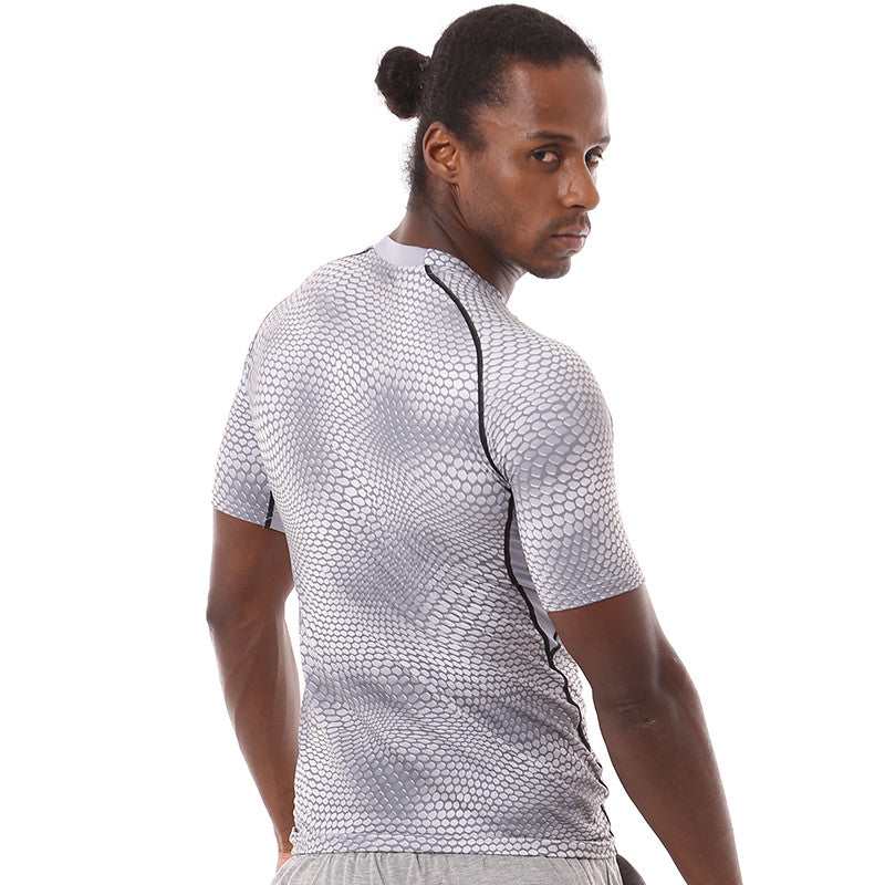 A man with long hair tied back wears an eprolo Mens Quick-Dry Serpentine Athletic Fit Compression T-Shirt and light gray shorts. He turns slightly, glancing over his shoulder against a plain white background, exuding cool confidence.