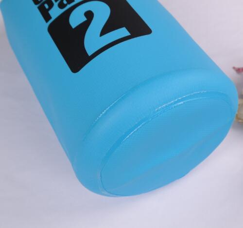 A close-up of the eprolo Aolikes 2L Ultralight Waterproof Dry Bag, a compact blue cylindrical bag with a black 2 on it, sitting on a white surface. Perfect for camping, hiking, and water sports adventures.