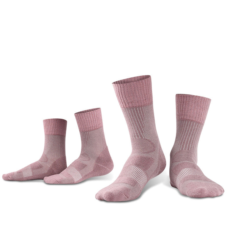 Three pairs of eprolos Outdoor Merino Wool Hiking Socks, designed for breathability and comfort, stand on their toes against a plain white background. With ribbed cuffs and patterns in pink shades, these cushioned sports socks are perfect for outdoor adventures.
