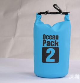The eprolo Aolikes 2L Ultralight Waterproof Dry Bag, with its blue design and black top, comes with an attached carabiner, making it perfect for camping, hiking, and water sports against any plain backdrop.