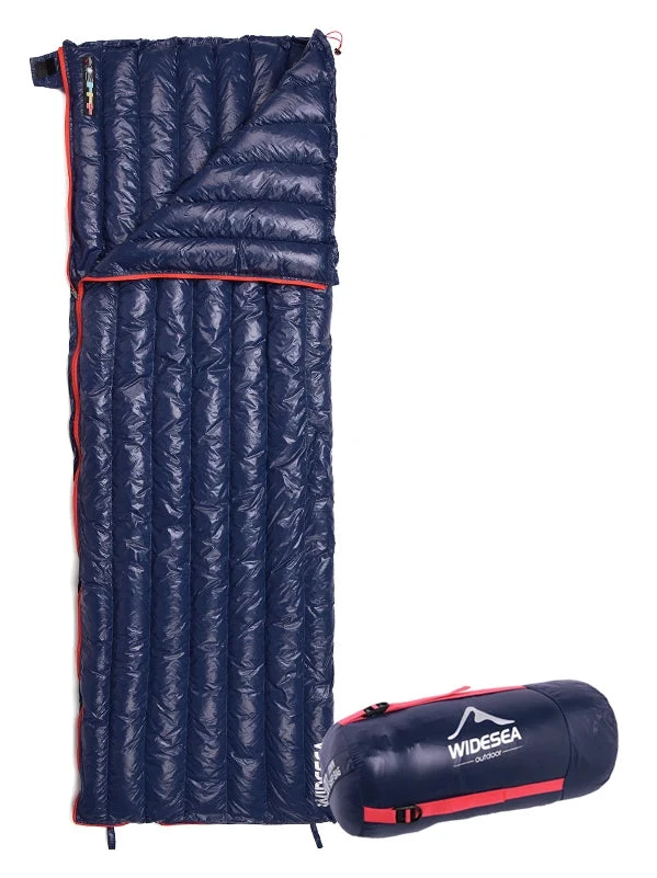 A navy blue Widesea Ultralight Down Sleeping Bag, featuring red accents, is shown partially unzipped on a white backdrop. The Ten Essentials logo is visible at the top left. It is accompanied by a compact carry bag with the same logo, emphasizing its waterproof nylon fabric.