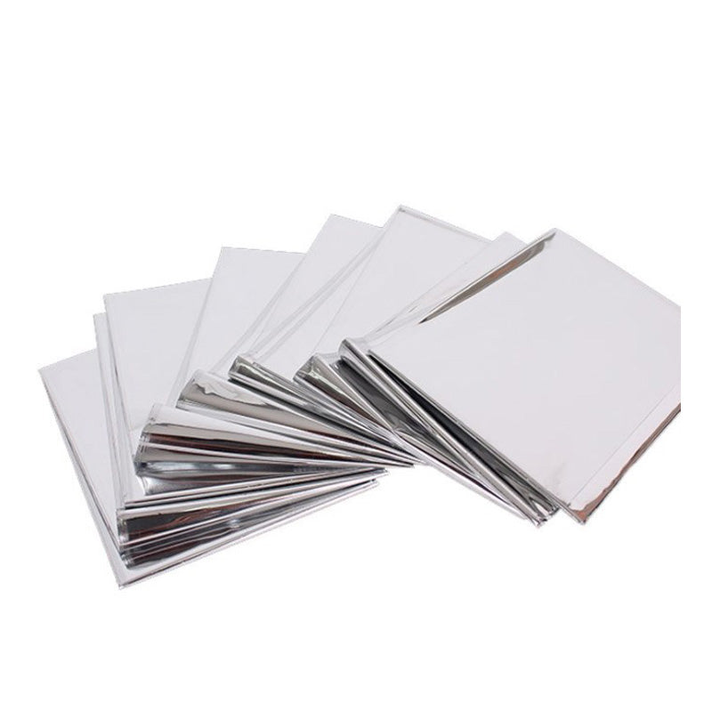 A stack of shiny sheets, resembling the Custom Outdoor Thermal Bivvy Survival Waterproof Emergency Sleeping Bag by Modalyst, is fanned out on a white background. With their smooth surface, these thin and pliable sheets could easily double as thermal layers in an emergency.