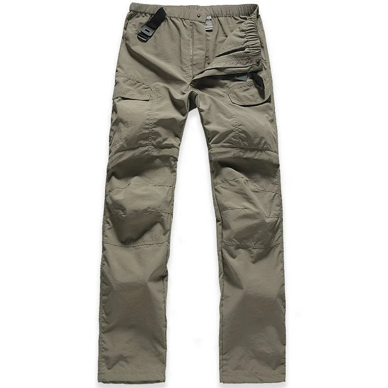 The NUONEKO Women’s Convertible Hiking Pants by Ten Essentials feature an olive green design with multiple pockets, adjustable waistband, reinforced knees, and a black plastic buckle. Made from quick-dry, water-resistant fabric, they’re ideal for outdoor activities with a zip fly and partially closed waist.