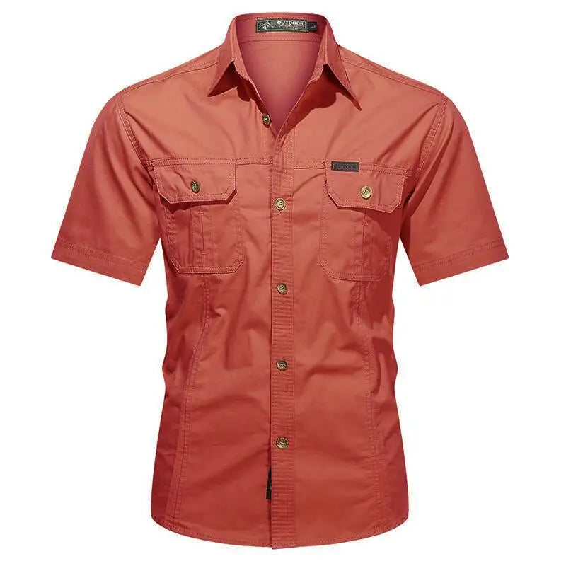 The Men’s Quick-Dry Tactical Shirt by Ten Essentials features a military-inspired design with two chest pockets and buttoned flaps. This red, short-sleeve, button-up shirt has a turned-down collar and front buttons, crafted from breathable cotton for comfort.