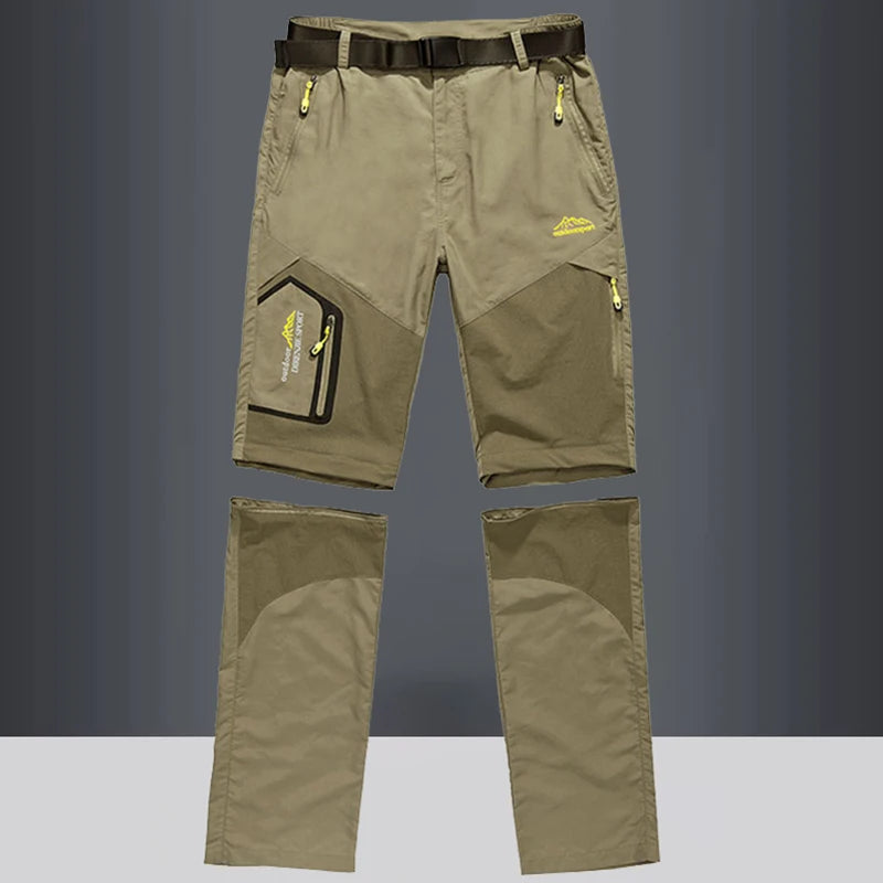 The Ten Essentials Men’s Convertible Quick-Dry Hiking Pants in olive green feature detachable legs, yellow zipper accents, a black belt, and multiple pockets. These stretch cargo travel pants are perfect for outdoor adventures. Displayed against a gray background.