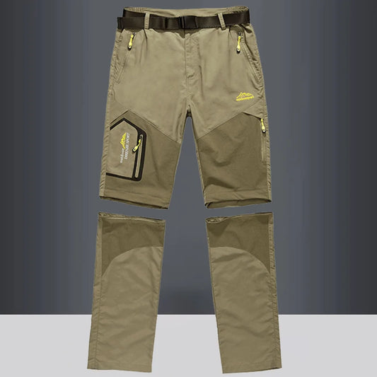 The Ten Essentials Men’s Convertible Quick-Dry Hiking Pants in olive green feature detachable legs, yellow zipper accents, a black belt, and multiple pockets. These stretch cargo travel pants are perfect for outdoor adventures. Displayed against a gray background.