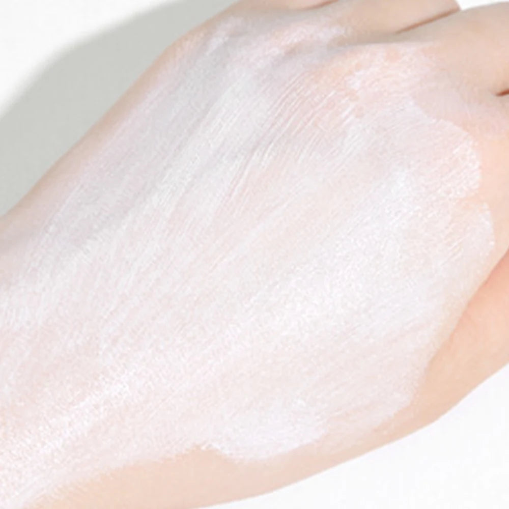 A hand adorned with a layer of Ten Essentials SPF 50+ Lasting Sunscreen Cream – an exquisite moisturizing and whitening sunblock – graces the skin, contrasting beautifully against a soft background.