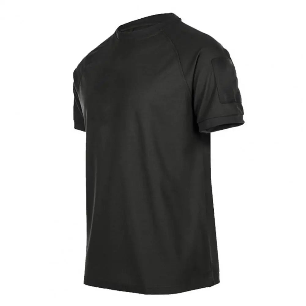 The Ten Essentials Men’s Quick-Dry Military T-Shirt is dark green with short sleeves, a round neck, and a small pocket on the left sleeve. This lightweight, breathable, moisture-wicking shirt is displayed on a plain white background.