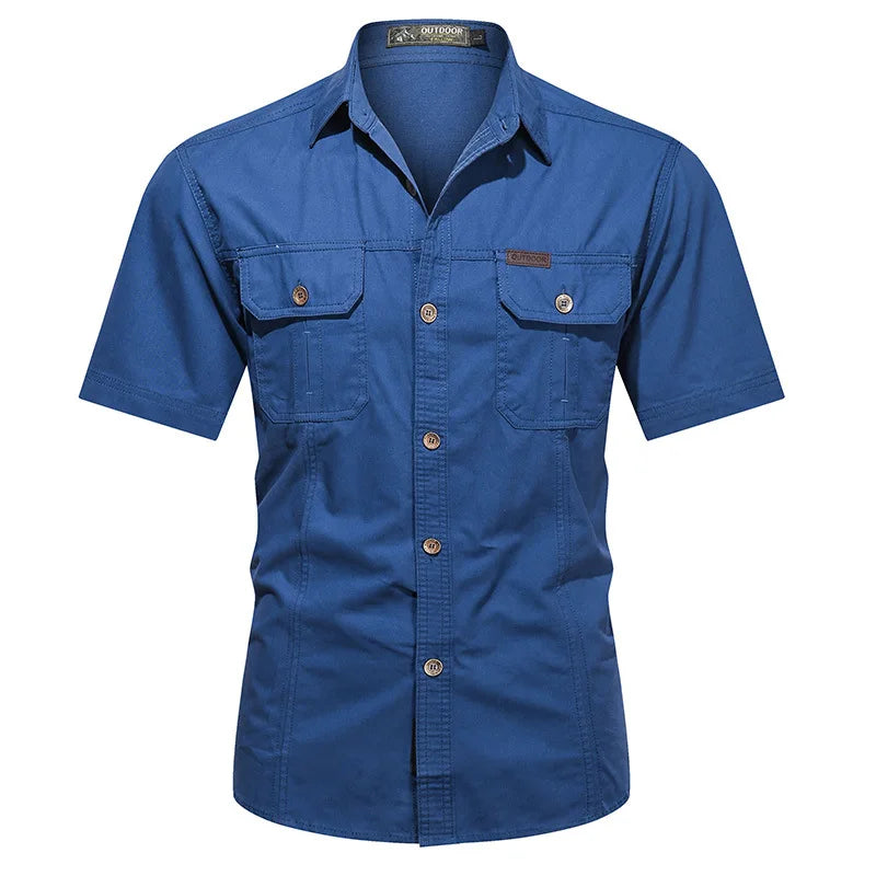 The Ten Essentials Men’s Quick-Dry Tactical Shirt is a blue short-sleeve, military-inspired button-up with a collar and two front chest pockets with flaps and buttons. Made from breathable cotton fabric, it is perfect for outdoor use.