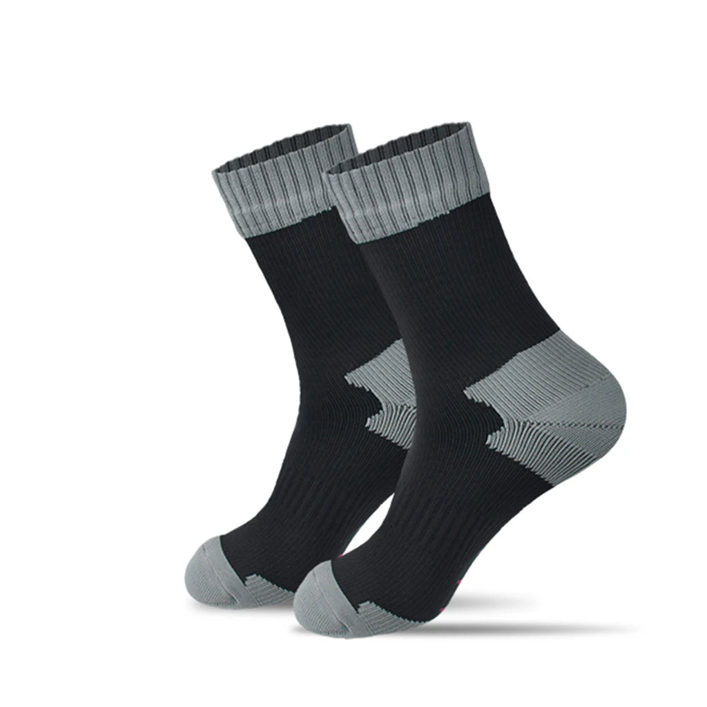 The Ten Essentials Waterproof Outdoor Sports Socks in black feature gray cuffs, heels, and toes. Set against a white background, their ribbed texture and contrasting colors stand out, making them ideal for warm, breathable hiking and skiing adventures.