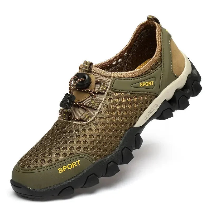 The Ten Essentials Men’s Breathable Mesh Sneakers are olive-green with brown accents, a black non-slip rubber sole, elastic laces with toggle, and SPORT printed on the side—ideal lightweight hiking shoes.
