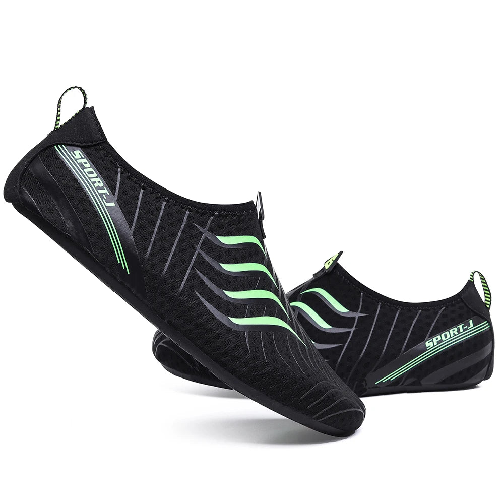 Ten Essentials offers Men’s Breathable Mesh Sneakers, featuring black designs with lime green and gray accents, a slip-on style with elastic bands. The word SPORT appears on the side. These lightweight barefoot sneakers feature quick-dry stretch fabric and non-slip EVA soles, ideal for aquatic activities.