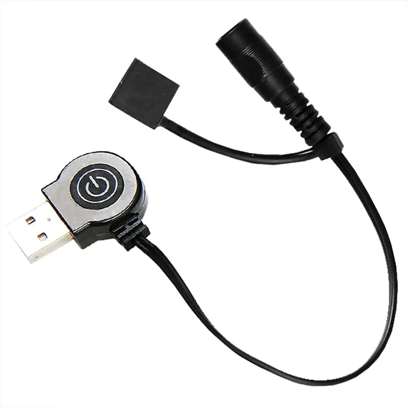The Ten Essentials USB Heated Sleeping Bag Pad features a sleek black USB cable with a circular switch featuring a power button symbol. It offers fast heating technology with adjustable 3-level temperature via both a USB connector and a round black adapter, contrasting beautifully against the white background.