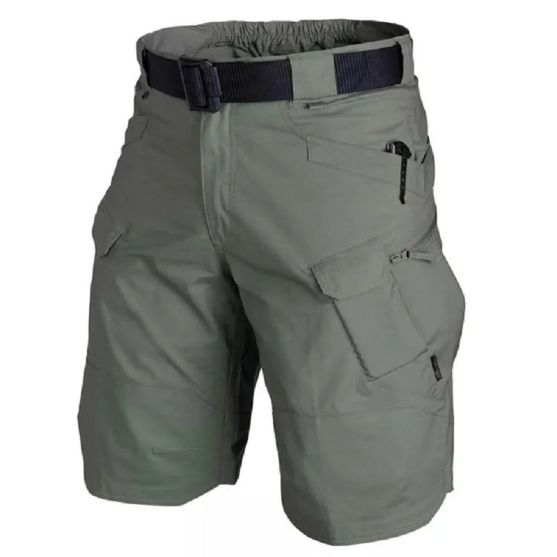 Ten Essentials Men’s Tactical Cargo Shorts in green are waterproof hiking shorts with a multi-pocket design and a black belt. Photographed on a white background, they offer lightweight breathability for style and functionality on any adventure.