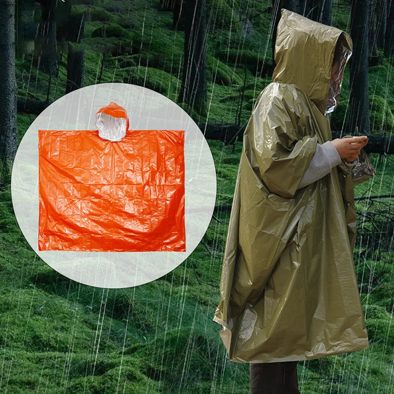A person wearing Ten Essentials Emergency Rain Poncho with Mylar Blanket Liner stands in the rain, viewing a device as the forest looms behind. An inset showcases the olive-green ponchos orange design, featuring a hood and advanced heat retention for warmth.