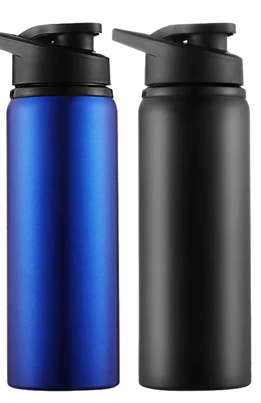 Two Ten Essentials Portable Stainless Steel Water Bottles - 700ml Sport & Travel Flask are shown side by side, with a metallic blue bottle featuring a black lid on the left and a matte black equivalent on the right. A color legend reads BLUE and BLACK with matching backgrounds.