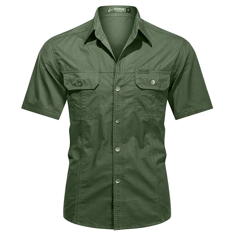 Ten Essentials Men’s Quick-Dry Tactical Shirt is a military-inspired, green short-sleeve shirt with two buttoned chest pockets. Made from breathable cotton fabric, it is neatly pressed and displayed on a plain white background.