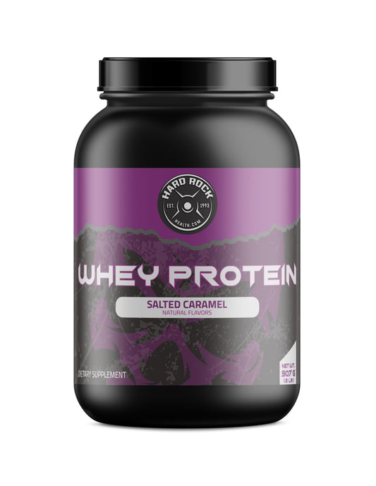 A Hard Rock Health container of Whey Protein in salted caramel flavor features a purple label with mountains, BCAAs, and weighs 907g or 2 lbs.