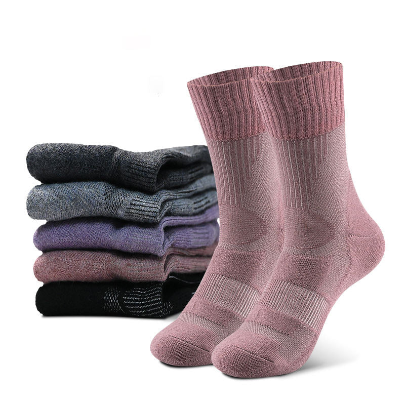 In the foreground, pink textured eprolo socks with a breathable design are perfect for adventures. Behind them is a stack of eprolo’s Outdoor Merino Wool Hiking Socks in gray, blue, purple, and black, featuring ribbed cuffs and cushioned midsole for a soft and thick feel.