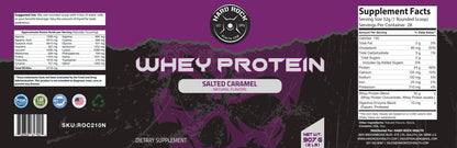 The Hard Rock Whey Protein - Salted Caramel package by Hard Rock Health features a skull design background, supplement facts, BCAAs benefits, certification logos, and weighs 907g (2lbs). The design is mostly dark with striking purple accents.