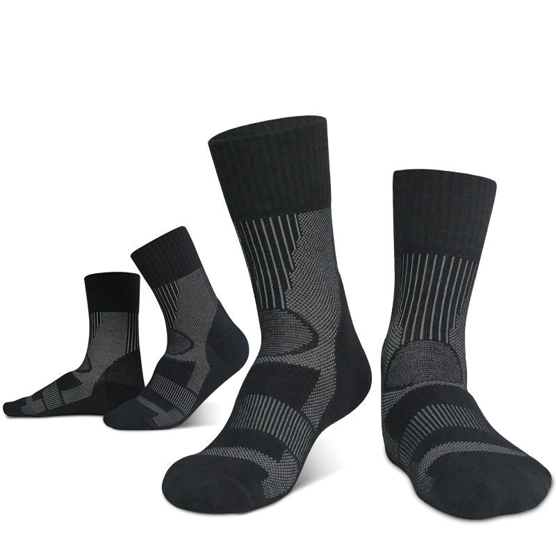 Four pairs of Outdoor Merino Wool Hiking Socks from eprolo are shown upright, highlighting their reinforced heel and toe features. Designed for outdoor adventures, these black and gray patterned socks offer a breathable, cushioned midsole to keep feet comfortable on any trail.