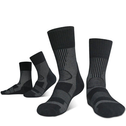 Four pairs of Outdoor Merino Wool Hiking Socks from eprolo are shown upright, highlighting their reinforced heel and toe features. Designed for outdoor adventures, these black and gray patterned socks offer a breathable, cushioned midsole to keep feet comfortable on any trail.