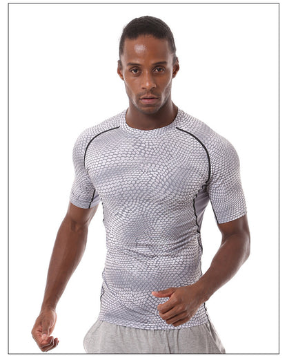 A man in a focused stance, ready to run, wears eprolos Mens Quick-Dry Serpentine Athletic Fit Compression T-Shirt for hiking and outdoor activities, paired with light gray pants against a white background.