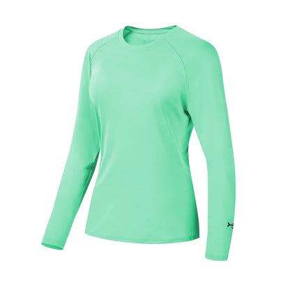 The Bassdash Womens UPF 50+ Long Sleeve Performance Shirt by Ten Essentials, designed for fishing and hiking, is a light green athletic shirt with 4-Way Stretch Technology. It features a round neckline and a small logo on the left sleeve. Displayed against a white background, its smooth texture stands out.