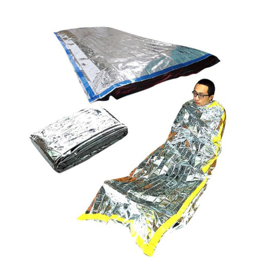 A person is wrapped in a shiny, reflective Custom Outdoor Thermal Bivvy Survival Waterproof Emergency Sleeping Bag by Modalyst, featuring a yellow border. The image displays the bivvy both folded and fully laid out, efficiently retaining body heat with its metallic material.