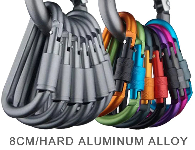 The Ten Essentials 4-Piece Aluminum Carabiner Travel Kit features colorful 8cm alloy carabiners in gray, orange, green, blue, purple, and red. Each durable and lightweight carabiner is labeled 8CM/HARD ALUMINUM ALLOY, ideal for camping and hiking.