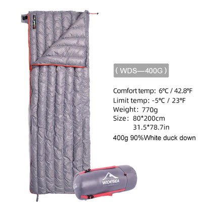 The grey Ten Essentials Widesea Ultralight Down Sleeping Bag unfolds to reveal a quilted pattern. Specifications: comfort temperature 6°C, limit -5°C, 770g weight, size 80x200cm with 400g of 90% duck down filling. Features waterproof nylon fabric and includes a storage bag.
