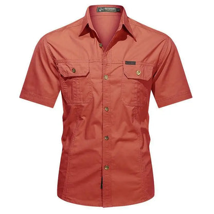 The Men’s Quick-Dry Tactical Shirt by Ten Essentials features a military-inspired design with two chest pockets and buttoned flaps. This red, short-sleeve, button-up shirt has a turned-down collar and front buttons, crafted from breathable cotton for comfort.
