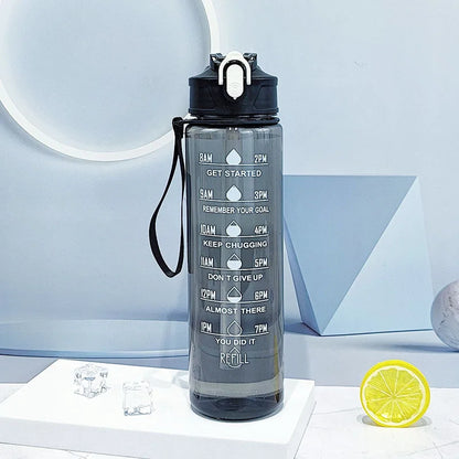 The Ten Essentials Sports Water Bottle with Time-Tracking & Leak-Proof Flip Cover (750-800ML) is displayed on a white surface. It has motivational markers from 8 AM to 6 PM, a black lid, carrying strap, and straw. Geometric shapes, lemon slices, and ice cubes create the perfect backdrop for everyday use.