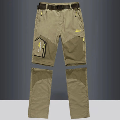 The Ten Essentials Men’s Convertible Quick-Dry Hiking Pants in olive green feature detachable legs, yellow zipper accents, a black belt, and multiple pockets. These stretch cargo travel pants are perfect for outdoor adventures. Displayed against a gray background.