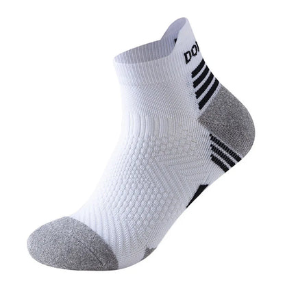 The Professional Marathon Running Socks by Ten Essentials are white, ribbed ankle socks with a gray toe/heel, featuring black heel stripes and a logo on the cuff. Engineered for comfort and breathability, these cushioned low-cut sports socks offer ultimate support for marathon runners.