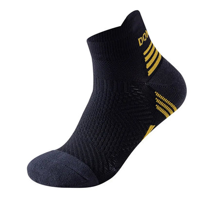The Ten Essentials Professional Marathon Running Socks are black ankle socks featuring breathable mesh, textured fabric, yellow stripes on the heel and ankle, a partially visible DOT at the top, ribbed cuffs, and reinforced toes for durability—ideal for marathon running.