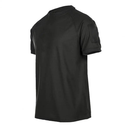 The Ten Essentials Men’s Quick-Dry Military T-Shirt is dark green with short sleeves, a round neck, and a small pocket on the left sleeve. This lightweight, breathable, moisture-wicking shirt is displayed on a plain white background.
