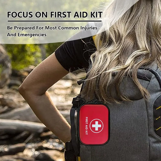 A person with long blonde hair carries a gray backpack containing a red Ten Essentials Portable First Aid Kit Bag for emergencies. Text reads, Focus on First Aid Kit: Be Prepared for Most Common Injuries and Emergencies, highlighting the significance of emergency readiness outdoors.