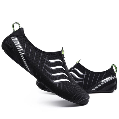 A pair of Ten Essentials Men’s Breathable Mesh Sneakers in black, with white wavy lines and a SPORT-I logo, featuring quick-dry fabric and green heel pull tabs. These lightweight non-slip hiking shoes offer a sporty design on a white backdrop.