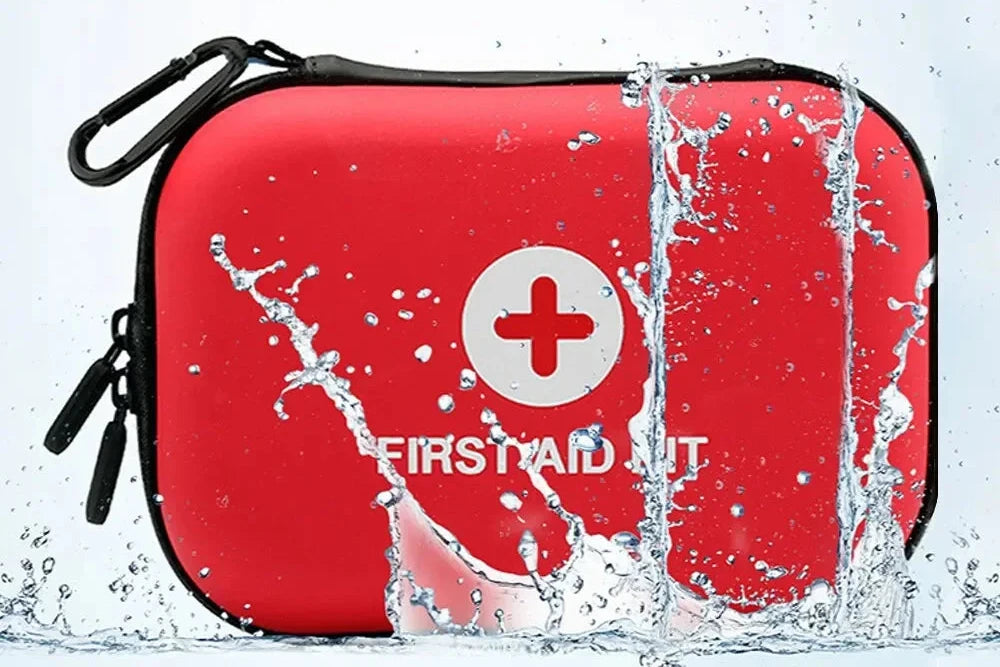 The Ten Essentials Portable First Aid Kit Bag, in red with a white cross and water droplets, is compact and designed for emergency preparedness. It features waterproof material with a black zipper and carabiner for easy attachment, meeting your medical storage needs at home or on the go.