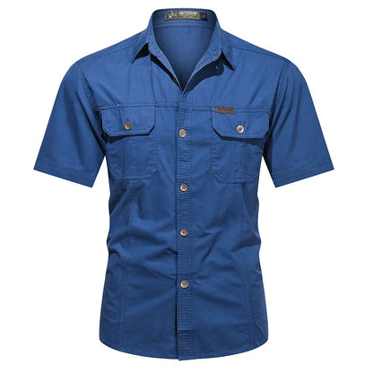 The Ten Essentials Men’s Quick-Dry Tactical Shirt is a blue short-sleeve, military-inspired button-up with a collar and two front chest pockets with flaps and buttons. Made from breathable cotton fabric, it is perfect for outdoor use.